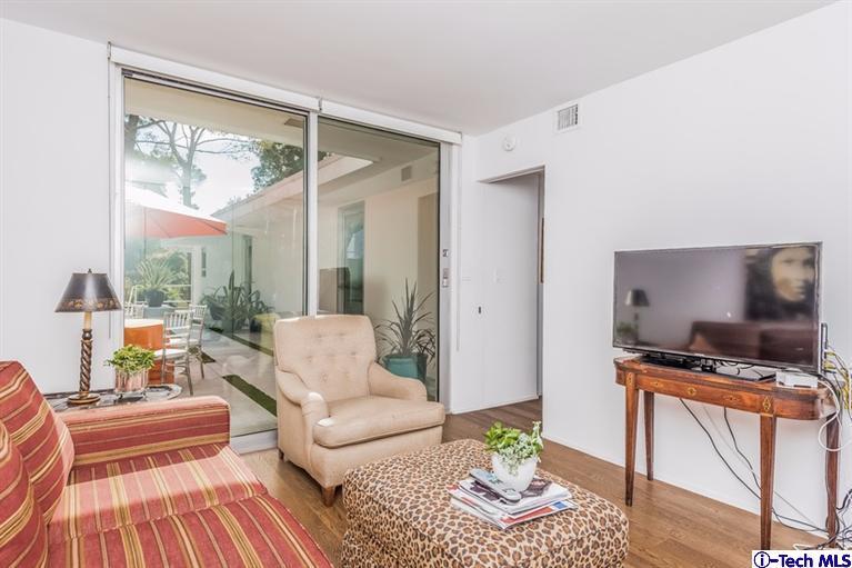 333 Manford Way Pasadena, CA 91105 - Photo 34 of 60 a living room with furniture a flat screen tv and a floor to ceiling window