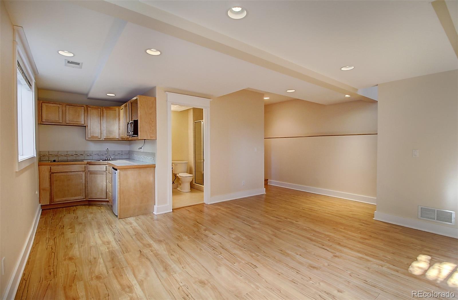 2942 4th Street Boulder, CO 80304 - Photo 18 of 22 a kitchen with granite countertop a refrigerator and a stove top oven