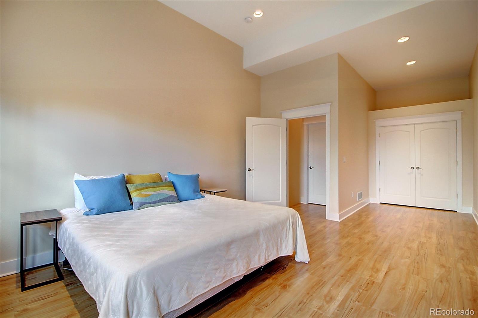 2942 4th Street Boulder, CO 80304 - Photo 20 of 22 a bedroom with a bed and wooden floor