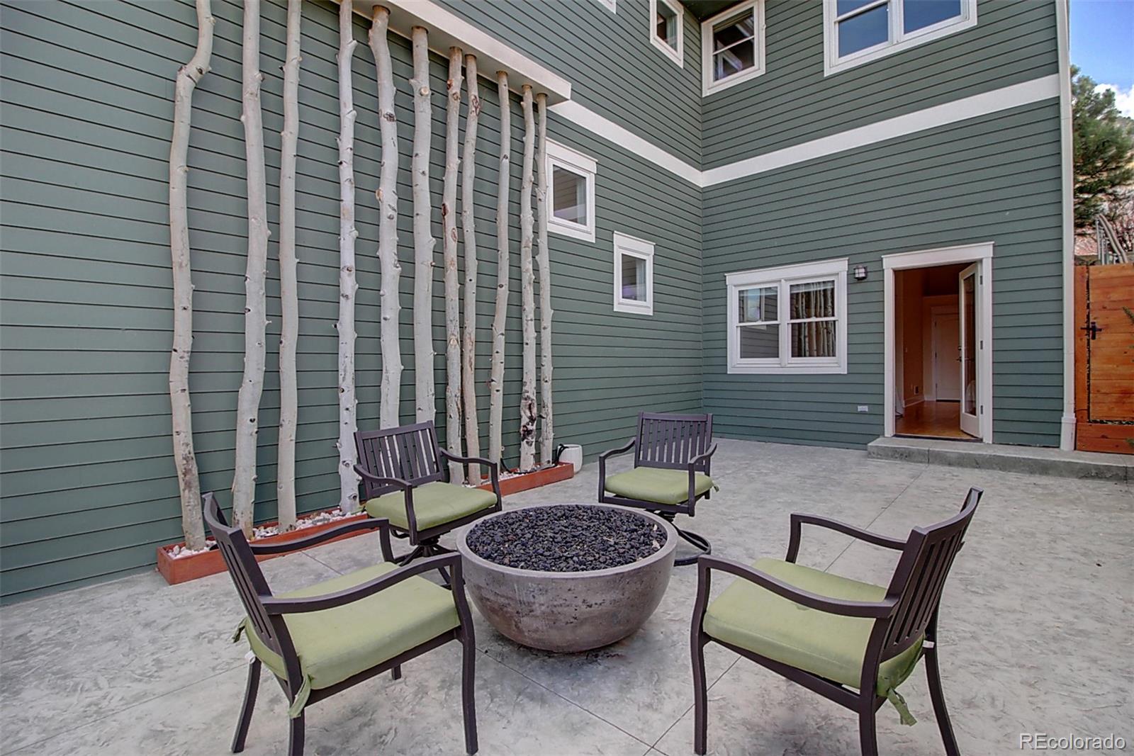 2942 4th Street Boulder, CO 80304 - Photo 3 of 22 a backyard of a house with barbeque oven table and chairs