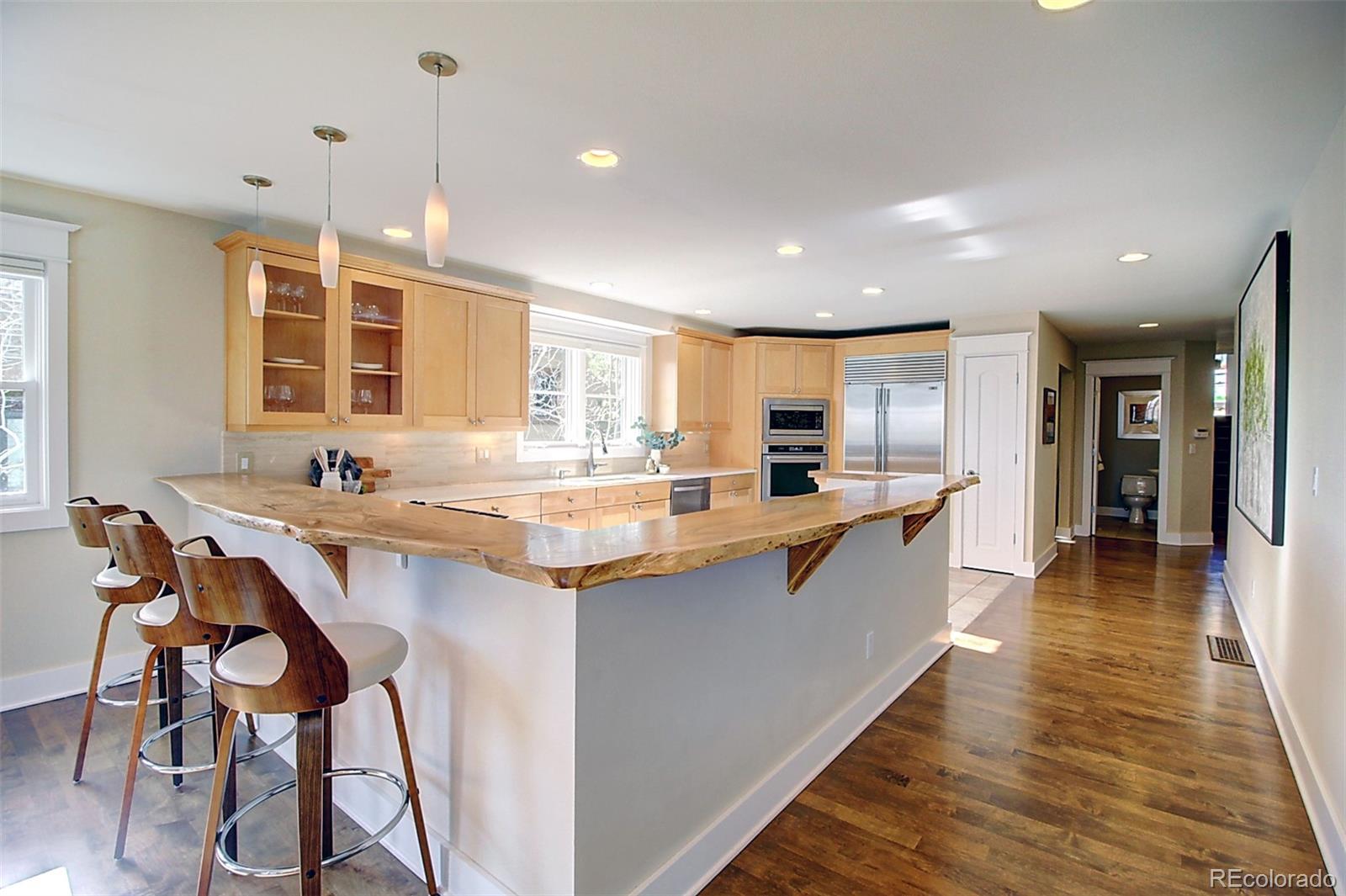 2942 4th Street Boulder, CO 80304 - Photo 4 of 22 a large kitchen with granite countertop lots of counter space dining table and stainless steel appliances