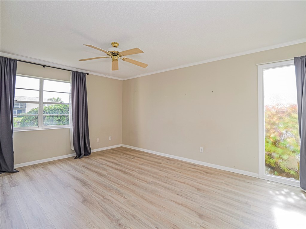 1860 Robalo Drive, Unit 105A Vero Beach, FL 32960 - Photo 13 of 35 wooden floor in an empty room with a window