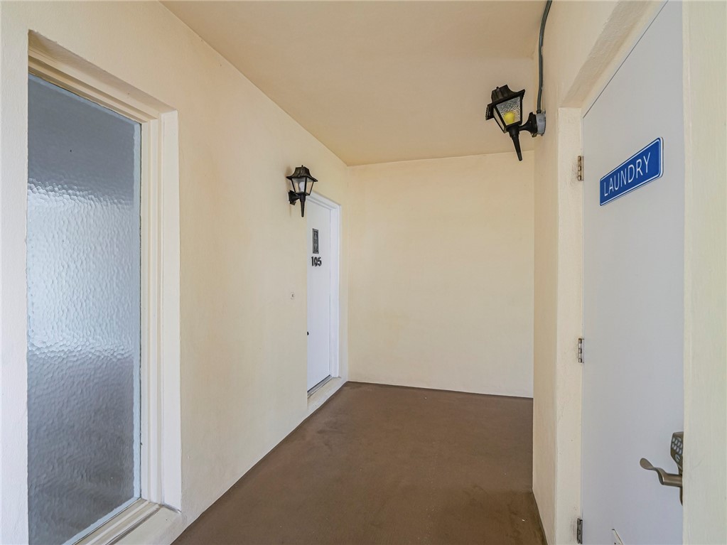 1860 Robalo Drive, Unit 105A Vero Beach, FL 32960 - Photo 2 of 35 a view of a hallway with a glass door