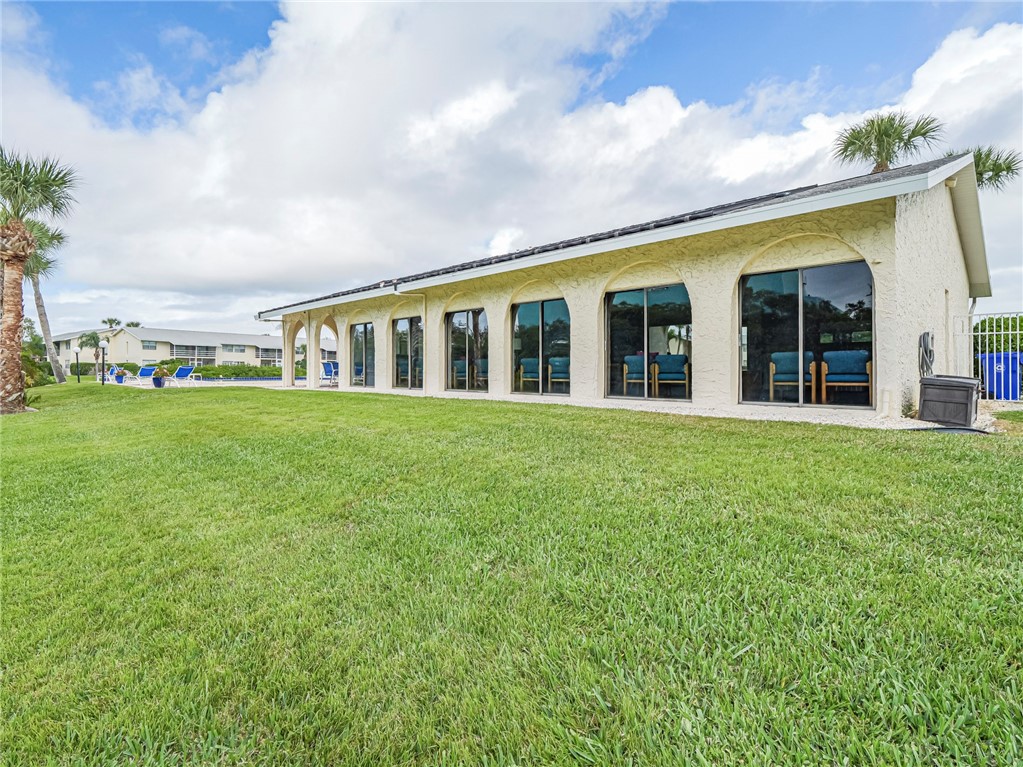 1860 Robalo Drive, Unit 105A Vero Beach, FL 32960 - Photo 24 of 35 front view of a house with a garden