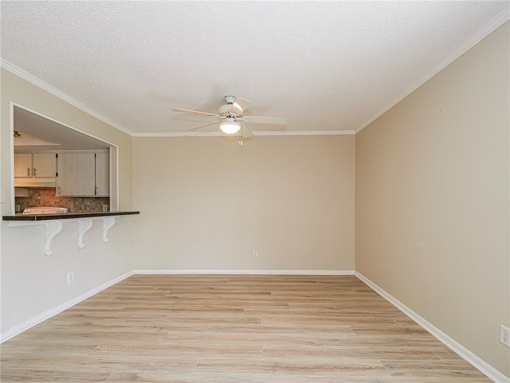 1860 Robalo Drive, Unit 105A Vero Beach, FL 32960 - Photo 8 of 35 a view of a room with wooden floor and fan
