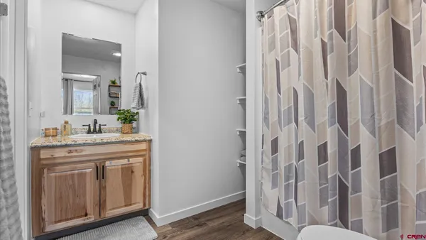 a bathroom with a toilet and a shower curtain