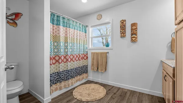 a kitchen with granite countertop a sink a stove and cabinets