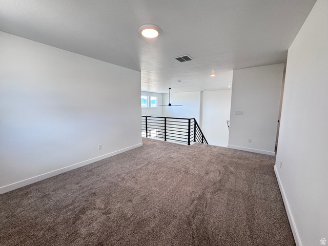 2613 Scarlet Road, Unit 258 Eagle Mountain, UT 84005 - Photo 25 of 33 Carpeted upper-level landing featuring a contemporary horizontal metal railing, white walls, and a flush-mount ceiling light