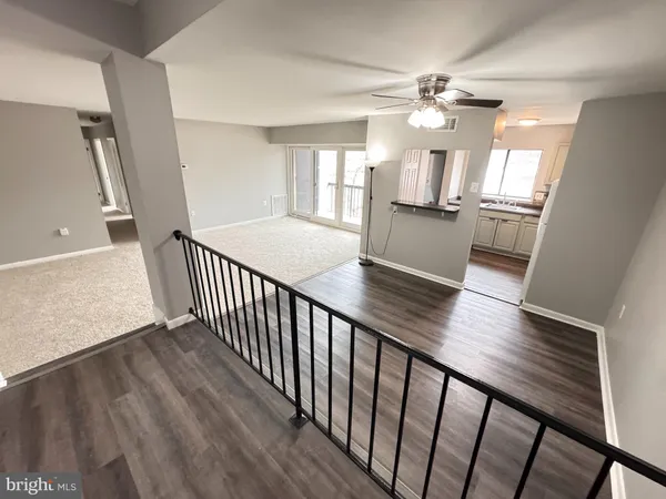 a view of a hallway view with wooden floor and staircase
