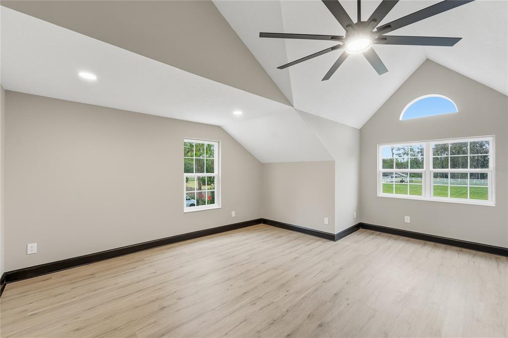 14728 Henson Road Orlando, FL 32832 - Photo 21 of 79 an empty room with wooden floor fan and windows