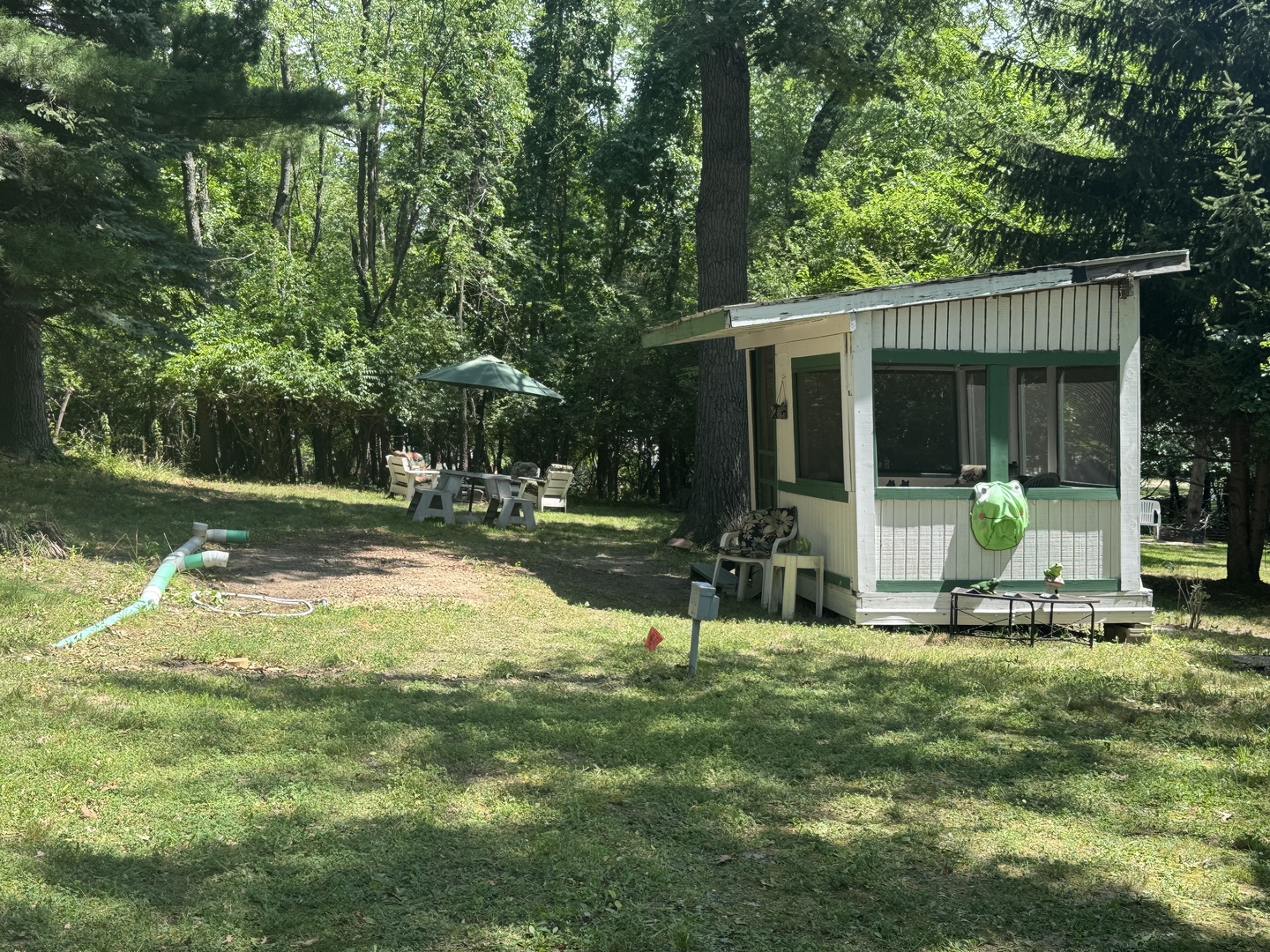a view of a chair and table in backyard of the house