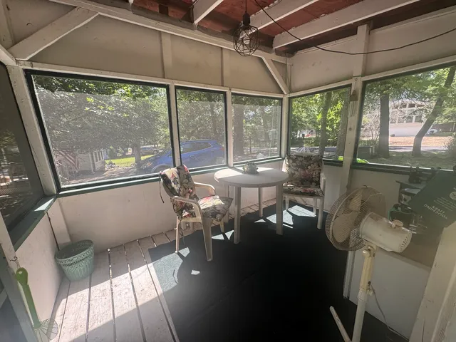 a balcony with chairs and table