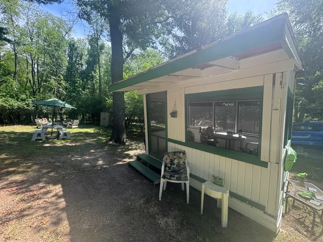 a view of a patio with table and chairs with wooden floor and fence