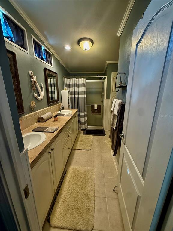 3530 Rossmere Road Port Charlotte, FL 33953 - Photo 14 of 32 a bathroom with a sink a mirror and shower