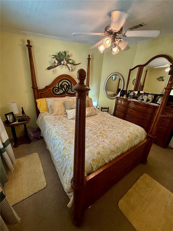 3530 Rossmere Road Port Charlotte, FL 33953 - Photo 16 of 32 a bedroom with a bed and dresser