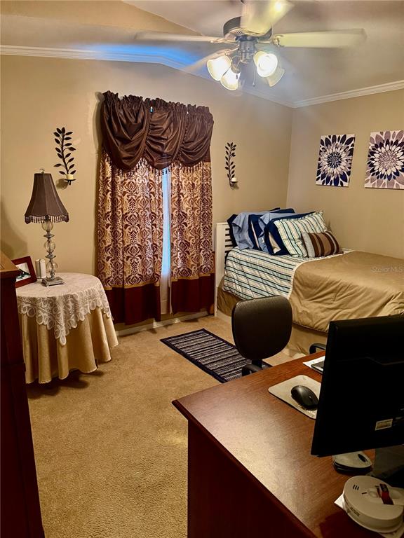 3530 Rossmere Road Port Charlotte, FL 33953 - Photo 17 of 32 a bedroom with a bed and a chandelier
