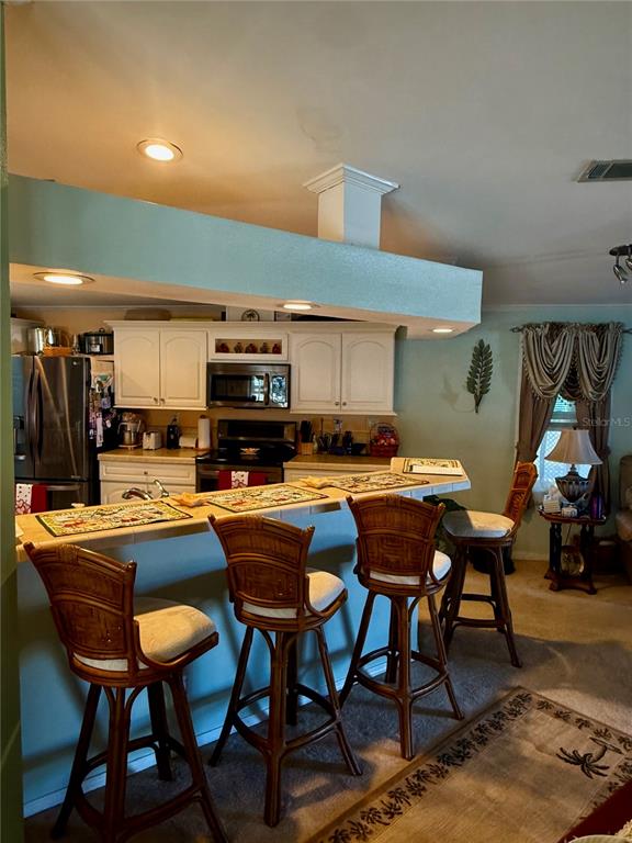 3530 Rossmere Road Port Charlotte, FL 33953 - Photo 22 of 32 a room with a table chairs and a dining table