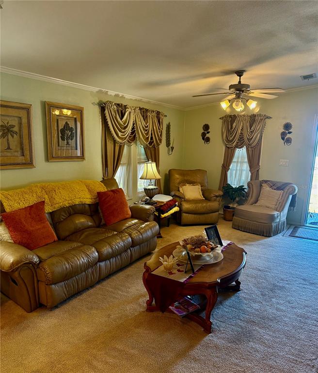 3530 Rossmere Road Port Charlotte, FL 33953 - Photo 25 of 32 a living room with furniture a chandelier and a rug