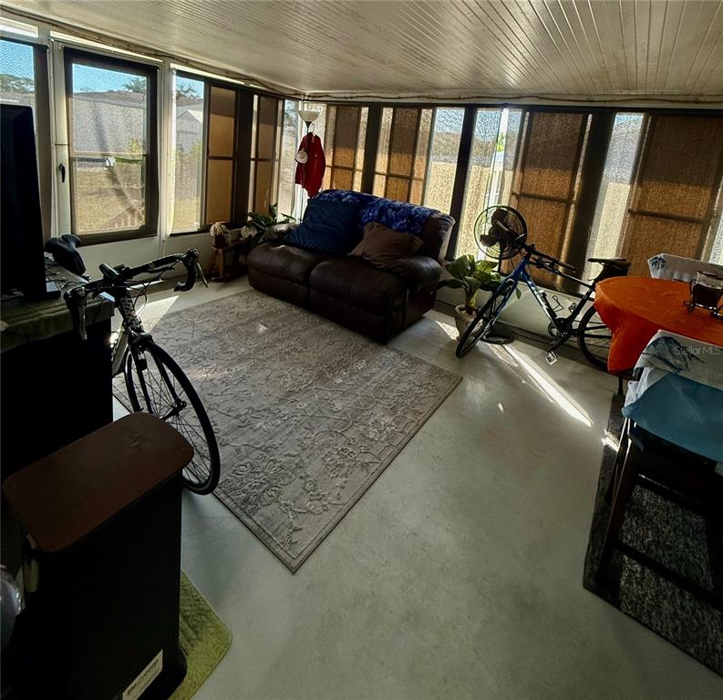 3530 Rossmere Road Port Charlotte, FL 33953 - Photo 29 of 32 a living room with furniture and a floor to ceiling window