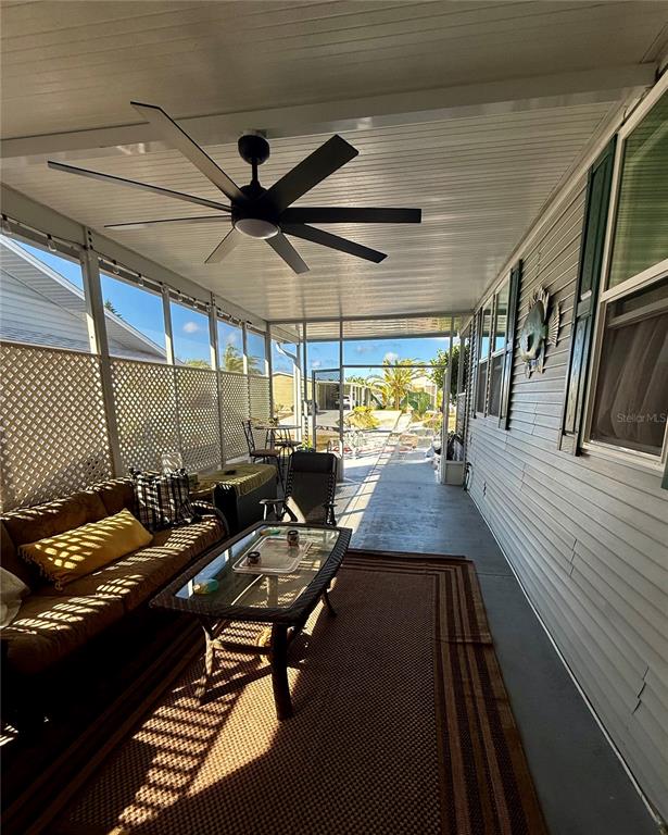 3530 Rossmere Road Port Charlotte, FL 33953 - Photo 32 of 32 a room with wooden floor table and chairs