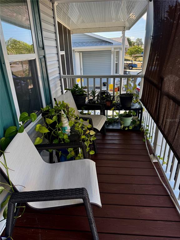 3530 Rossmere Road Port Charlotte, FL 33953 - Photo 5 of 32 a view of balcony with outdoor seating and wooden floor