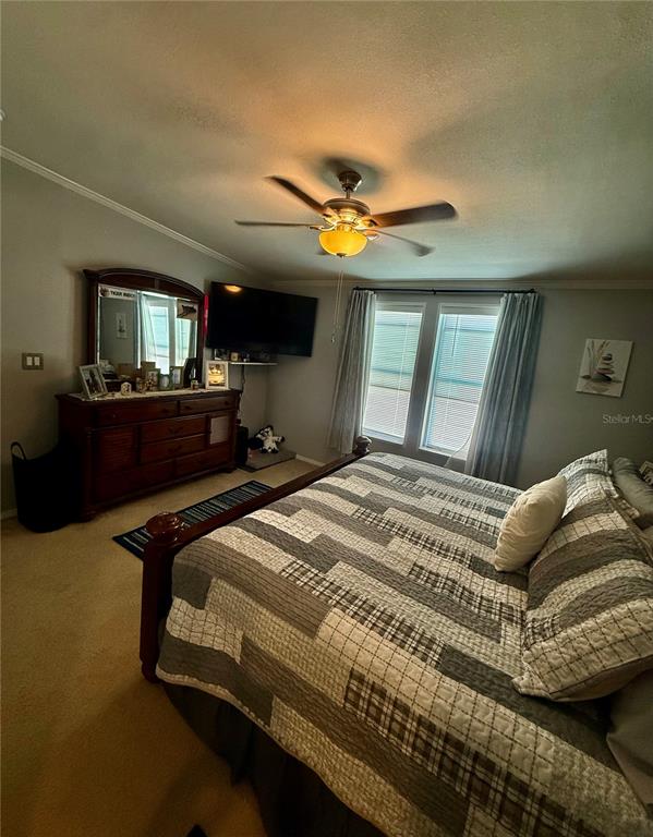 3530 Rossmere Road Port Charlotte, FL 33953 - Photo 10 of 32 a bedroom with a bed ceiling fan and a window