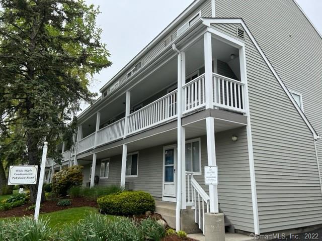 718 Cove Road, Unit 10 Stamford, CT 06902 - Photo 1 of 1 a front view of a house with a yard