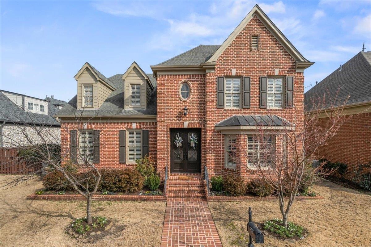 1436 Wolf Park Road Germantown, TN 38138 - Photo 2 of 40 Brick construction with professional landscaping and a striking iron door entrance that creates an impressive first impression.