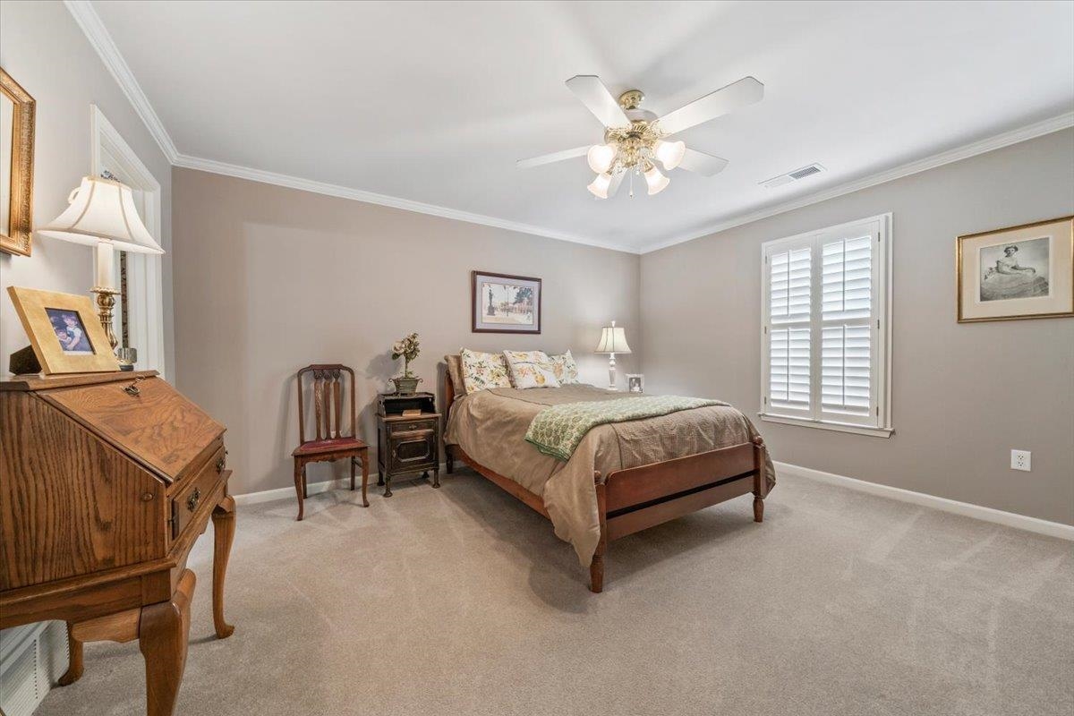 1436 Wolf Park Road Germantown, TN 38138 - Photo 26 of 34 a bedroom with a bed and a chandelier