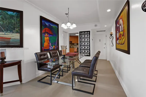 a living room with furniture chandelier and a window