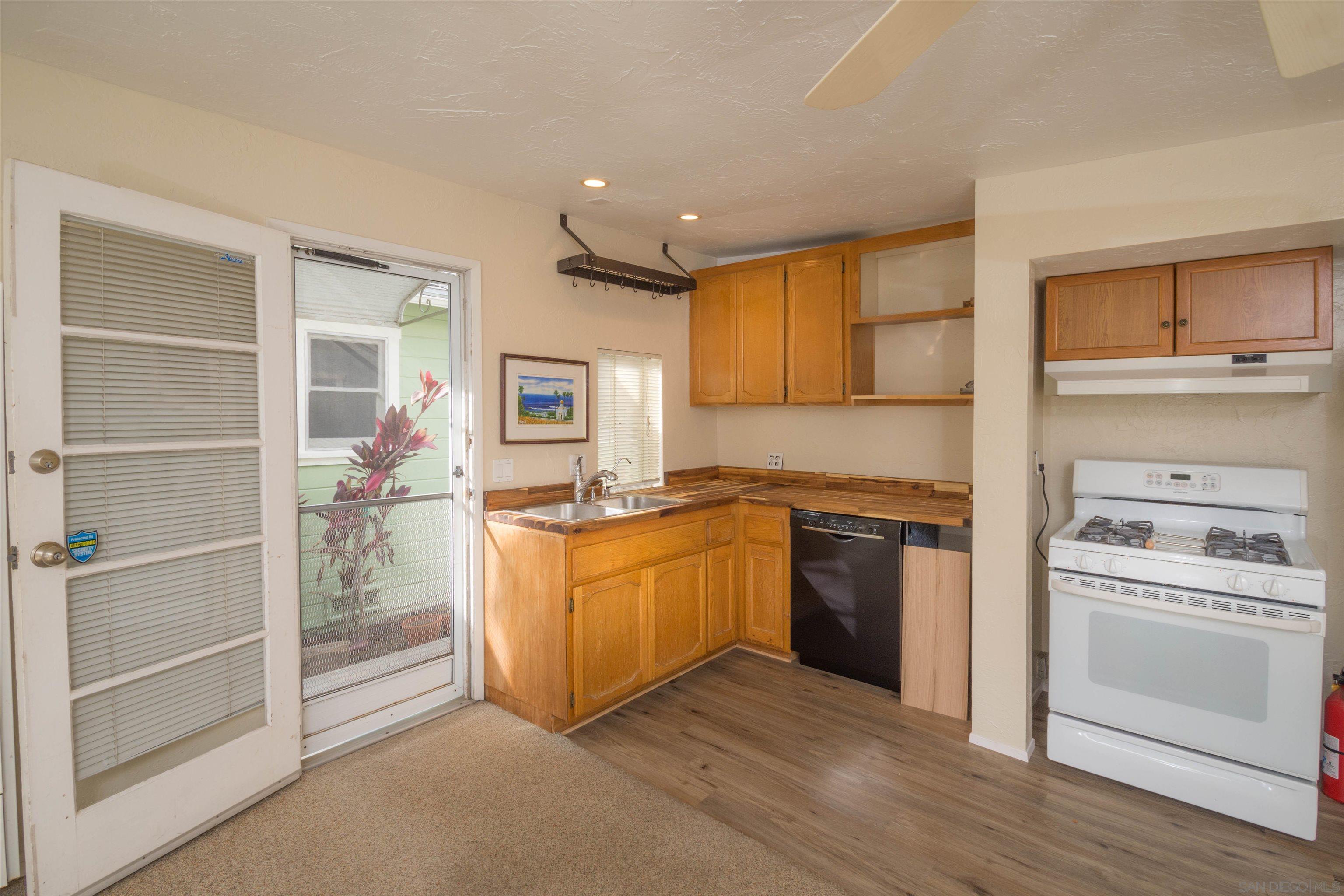 3218 Eureka Place, Unit B Carlsbad, CA 92008 - Photo 3 of 18 a kitchen with stainless steel appliances granite countertop a stove and a refrigerator