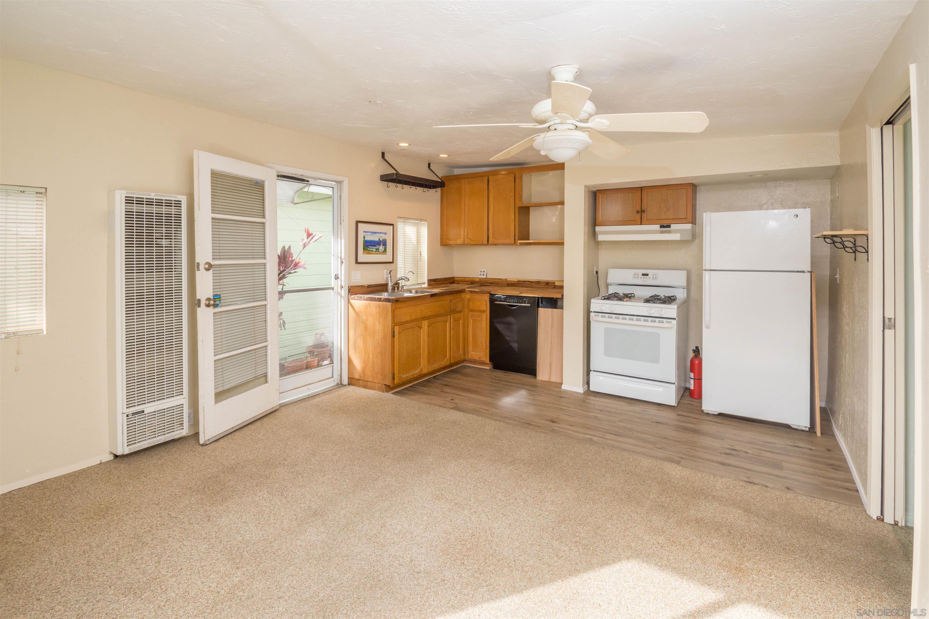 3218 Eureka Place, Unit B Carlsbad, CA 92008 - Photo 4 of 18 a view of a kitchen with a sink and a refrigerator