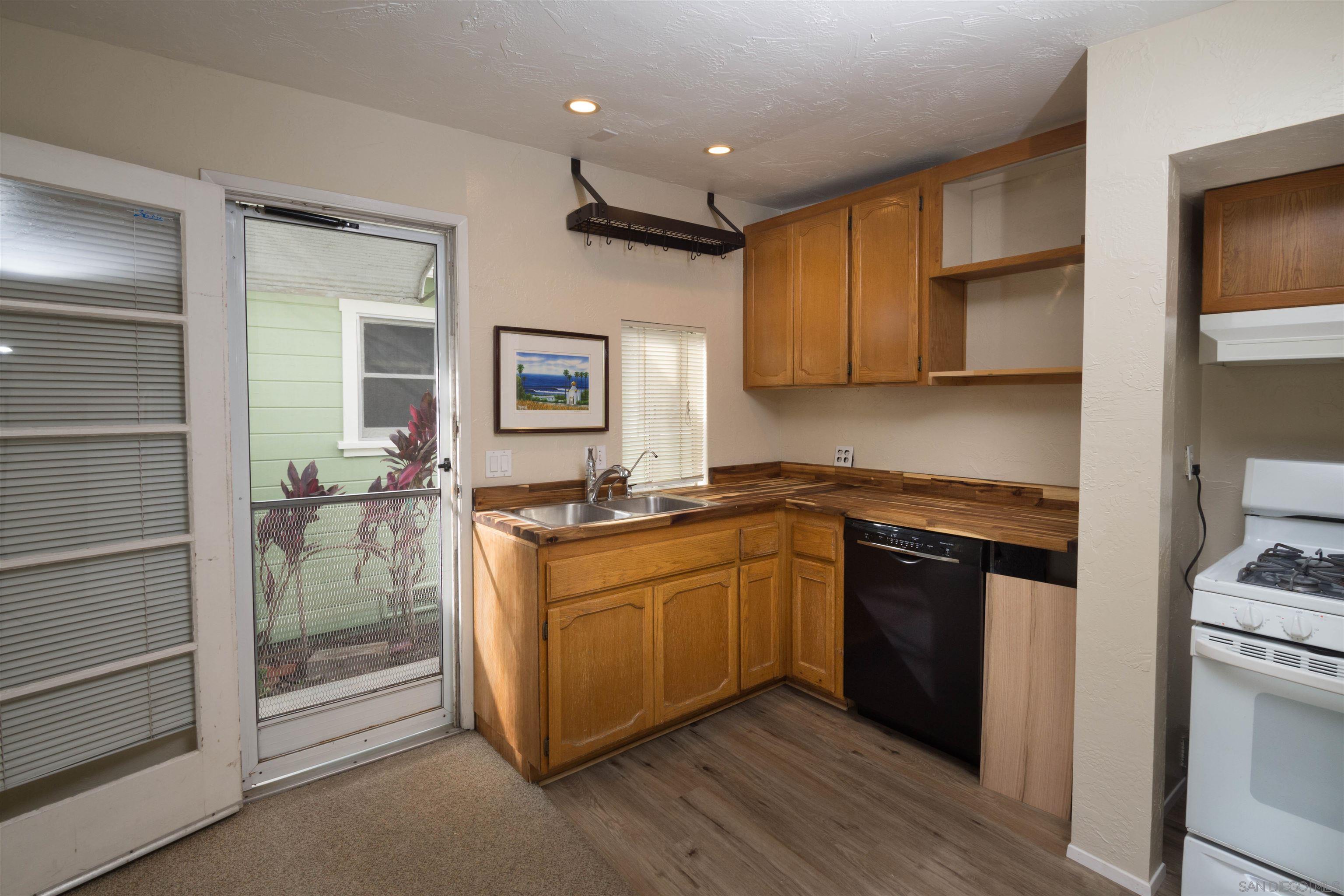 3218 Eureka Place, Unit B Carlsbad, CA 92008 - Photo 5 of 18 a kitchen with a refrigerator and a stove top oven