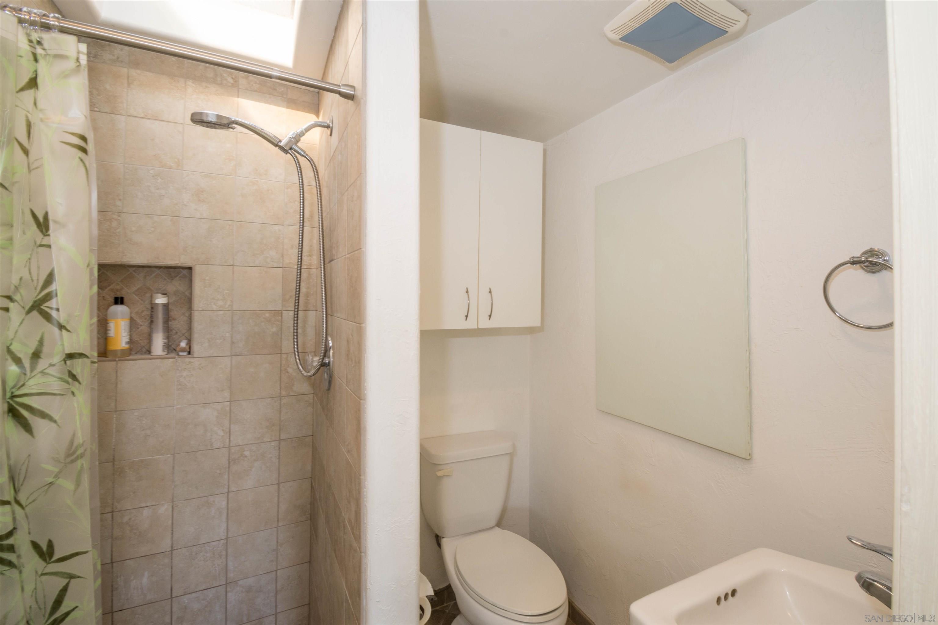 3218 Eureka Place, Unit B Carlsbad, CA 92008 - Photo 9 of 18 a white toilet sitting next to a bathroom sink