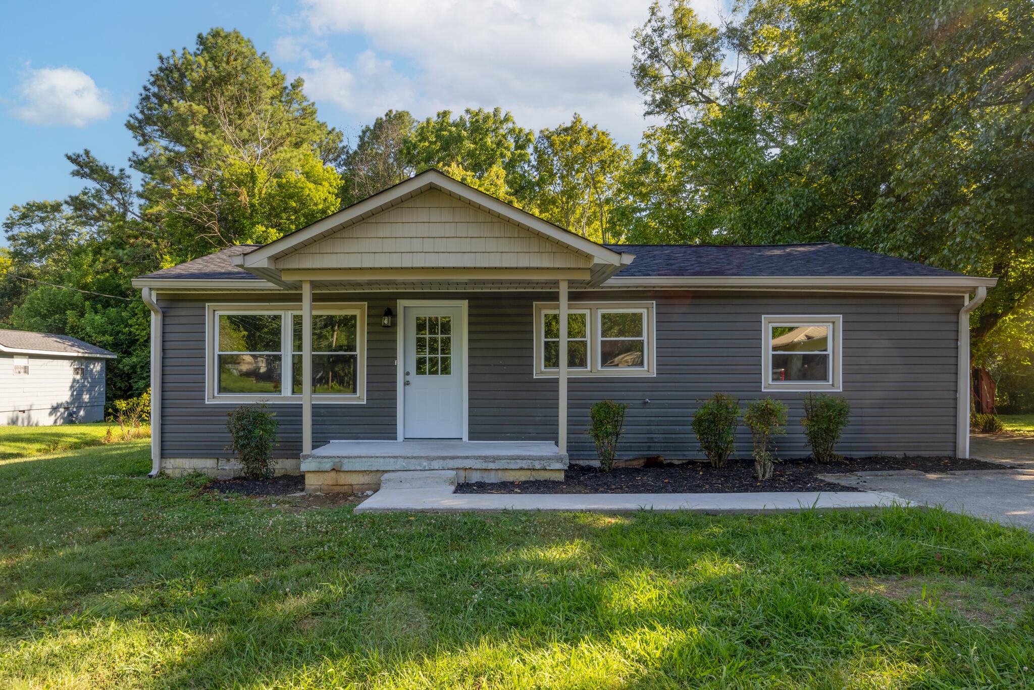 2002 Young Road Southeast Cleveland, TN 37323 - Photo 1 of 21 a front view of a house with a yard and outdoor seating