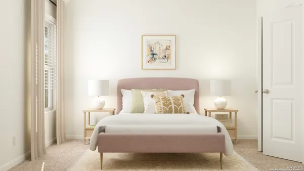 a bedroom with a bed and a painting on the wall