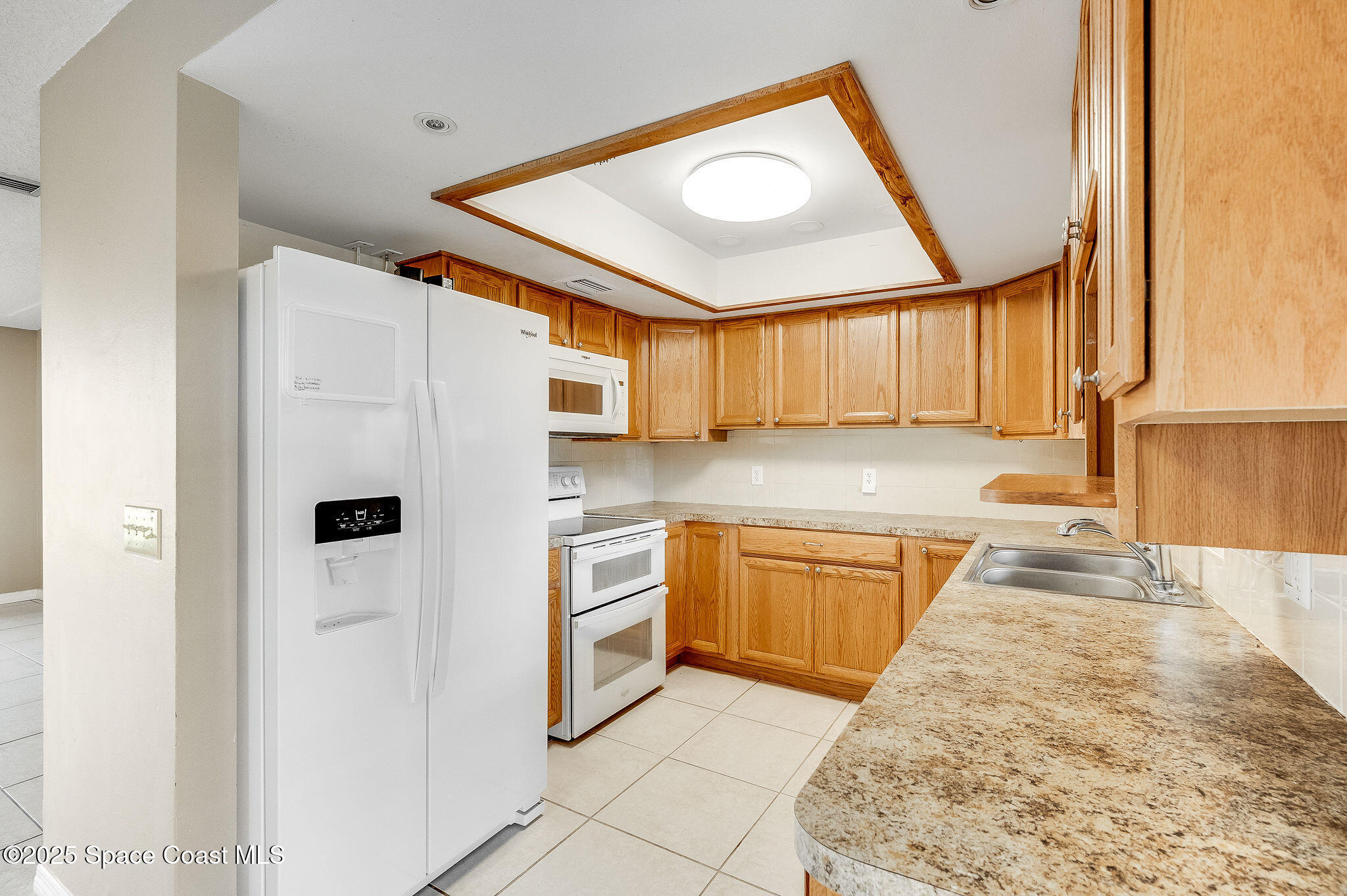 115 Angelo Road Southeast Palm Bay, FL 32909 - Photo 18 of 38 a kitchen with granite countertop a refrigerator and a stove