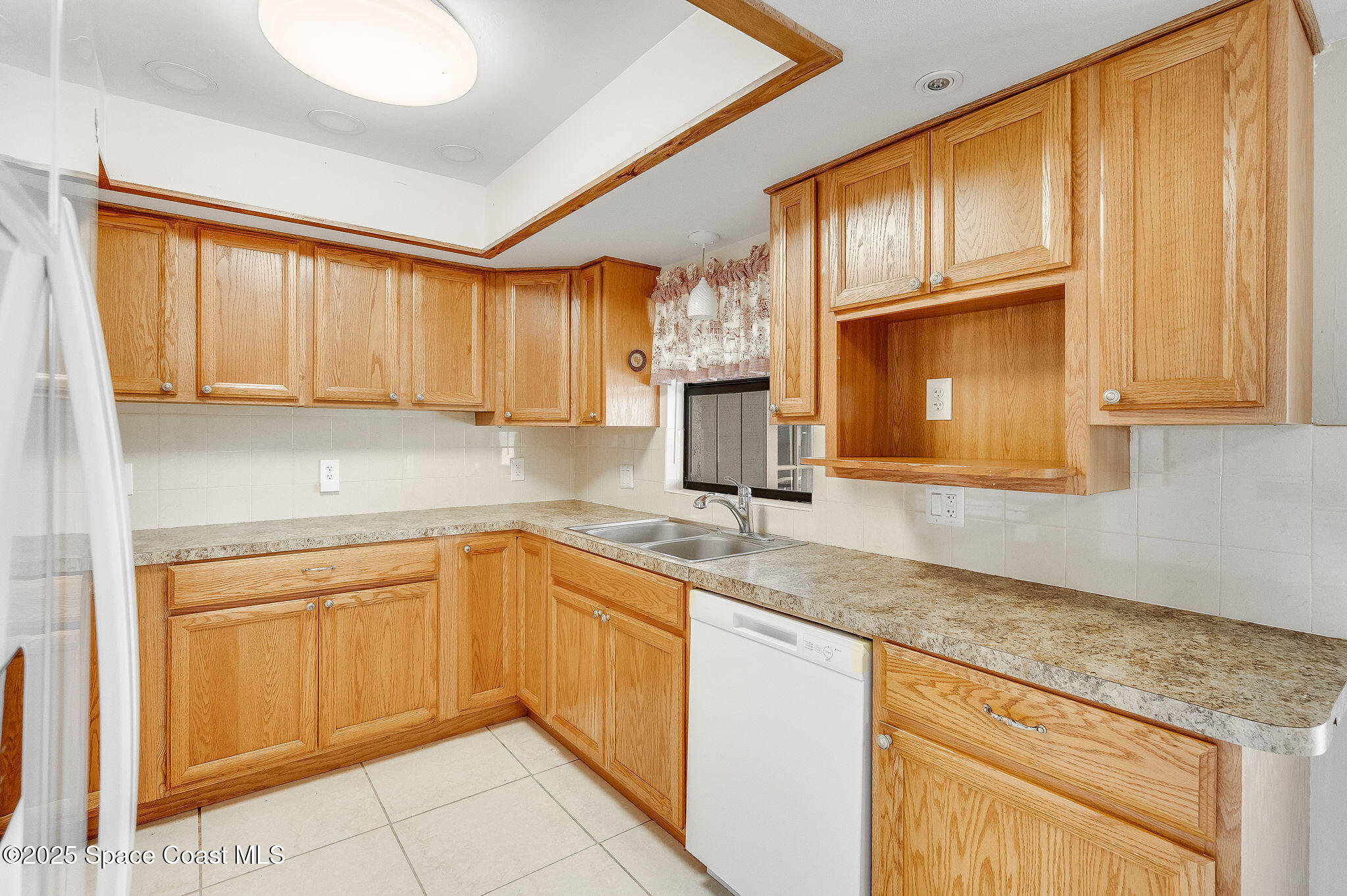 115 Angelo Road Southeast Palm Bay, FL 32909 - Photo 19 of 38 a kitchen with granite countertop cabinets sink and window