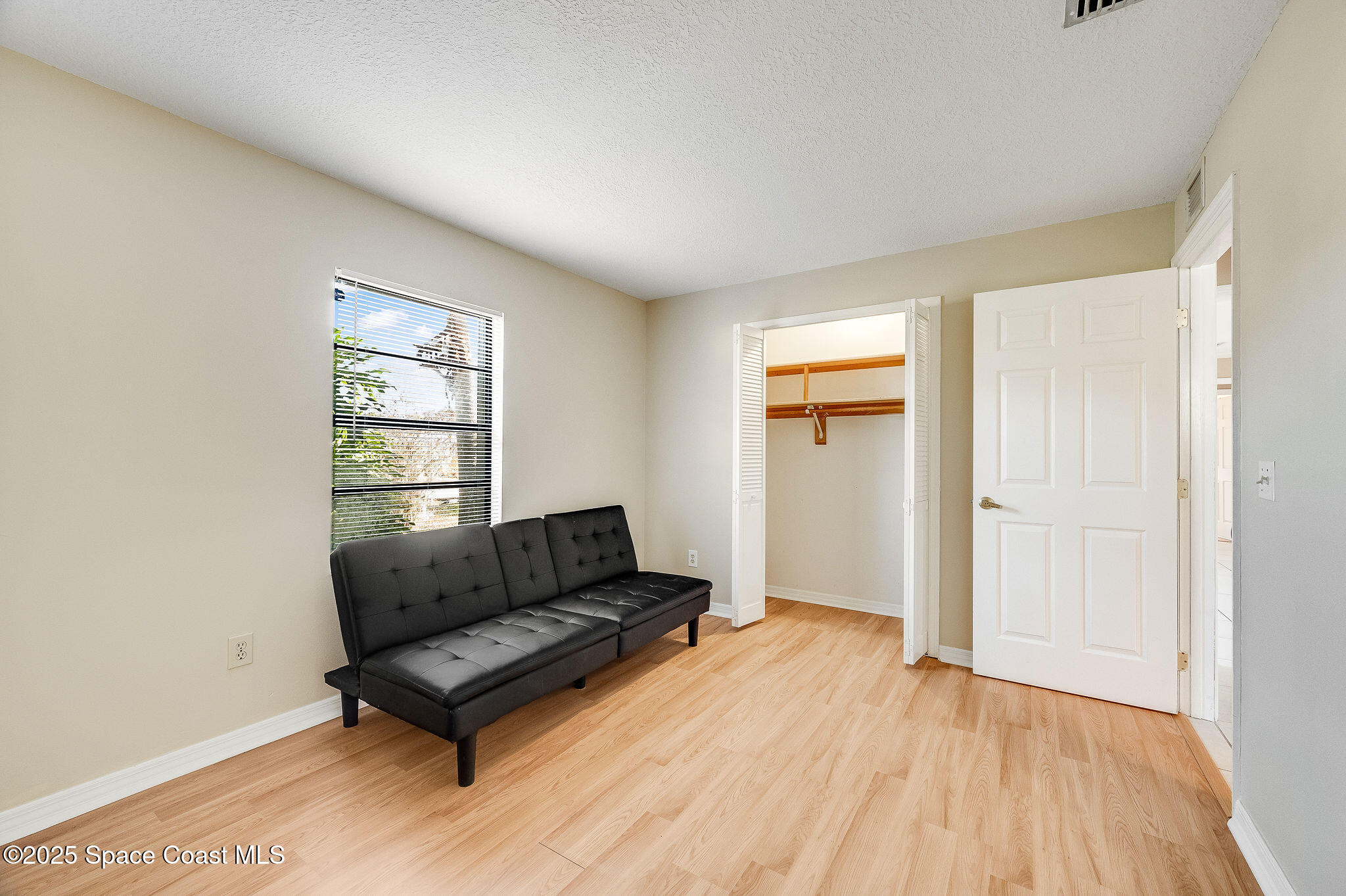 115 Angelo Road Southeast Palm Bay, FL 32909 - Photo 23 of 38 a living room with furniture and a window