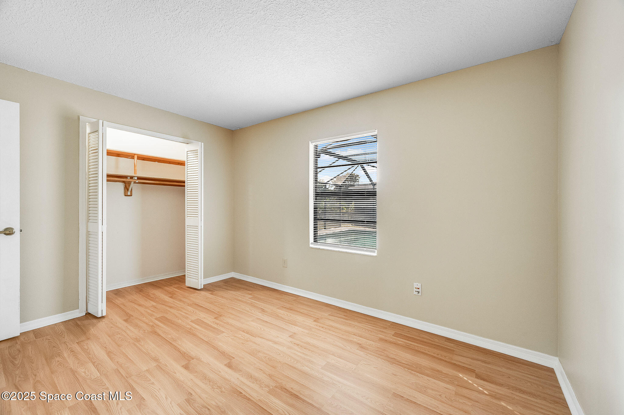 115 Angelo Road Southeast Palm Bay, FL 32909 - Photo 27 of 38 a view of empty room with wooden floor and fan