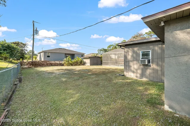 a view of a house with backyard and patio