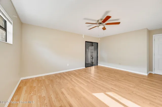 a view of empty room with ceiling fan