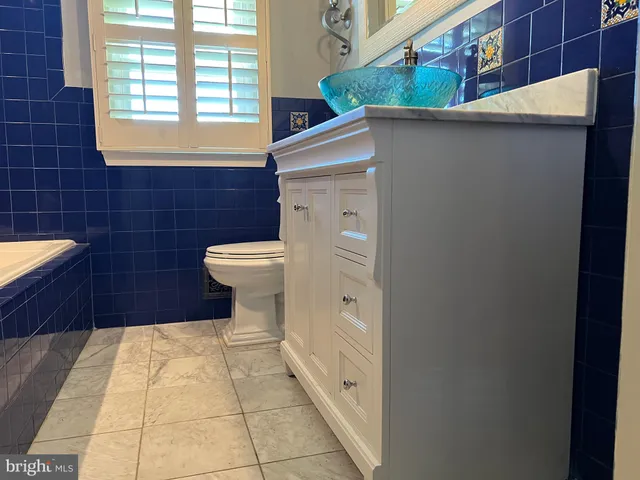 a bathroom with a toilet a sink and a window