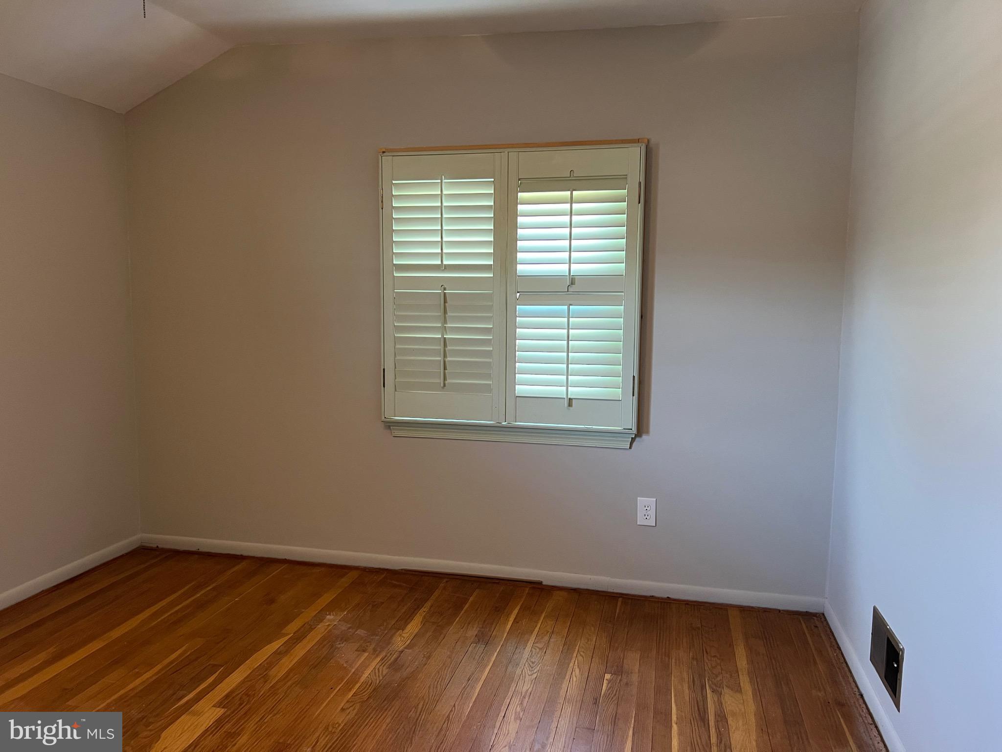 5808 Nystrom Street Hyattsville, MD 20784 - Photo 15 of 38 a view of an empty room with wooden floor and a window