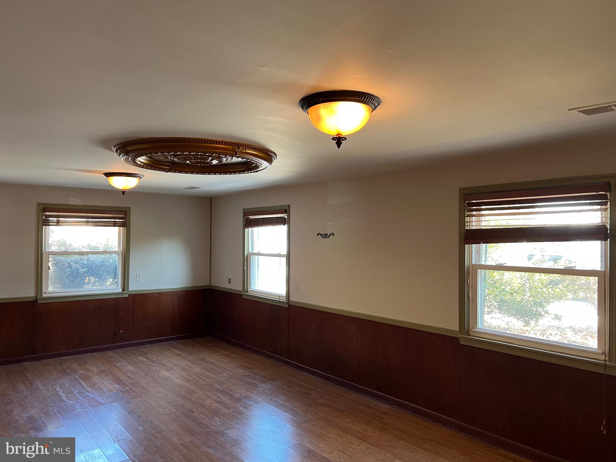5808 Nystrom Street Hyattsville, MD 20784 - Photo 21 of 38 an empty room with wooden floor and windows