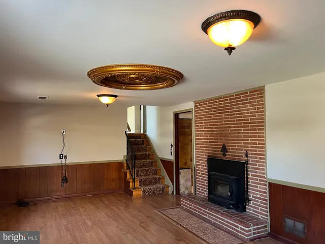 wooden floor in an empty room with a fireplace