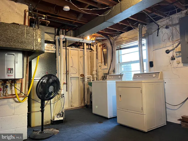 a view of a storage and utility room with washer and dryer