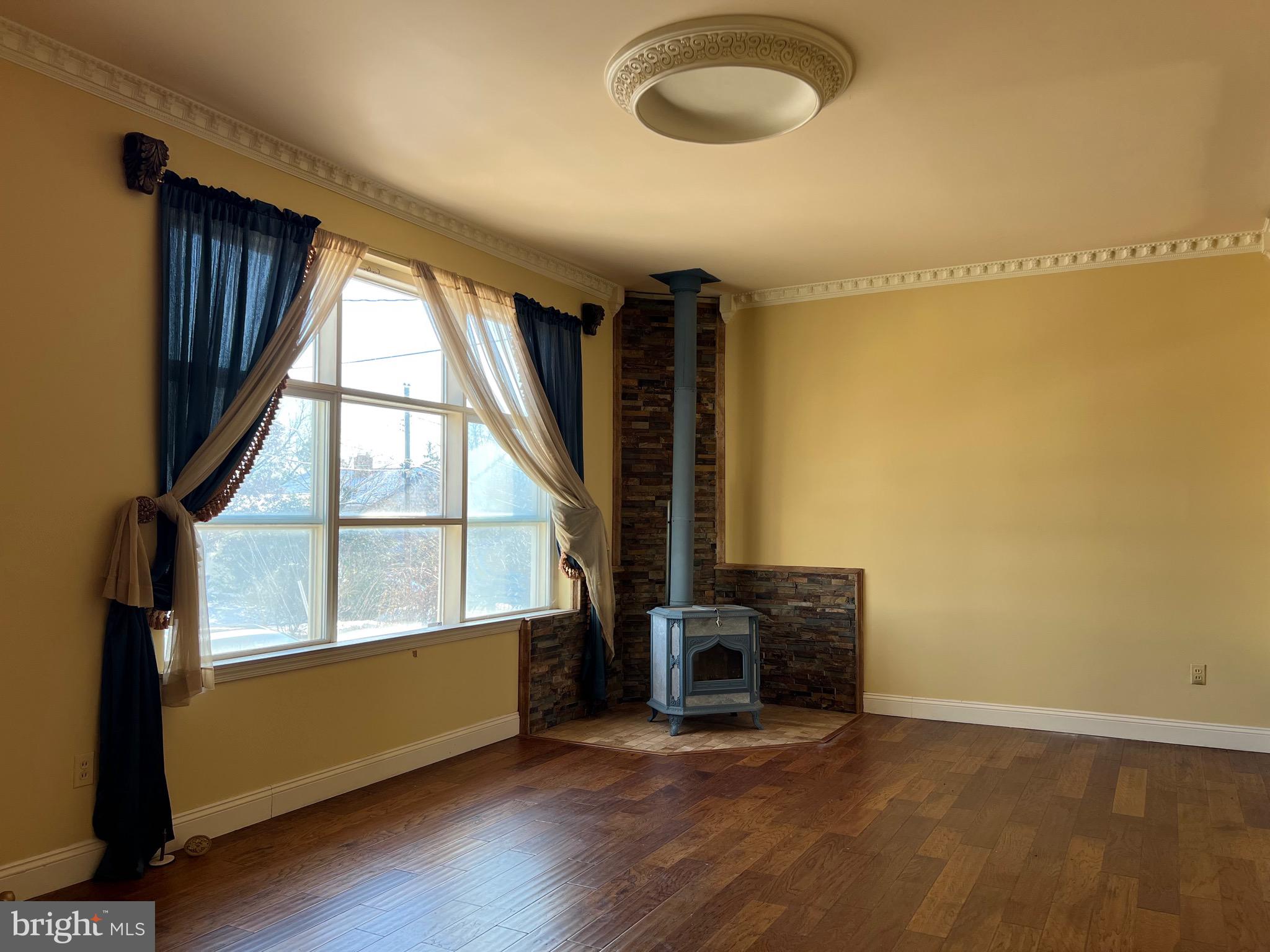 5808 Nystrom Street Hyattsville, MD 20784 - Photo 3 of 38 a view of an empty room with wooden floor and a window