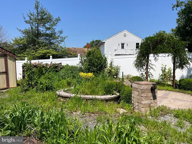 a front view of a house with a yard and a fountain