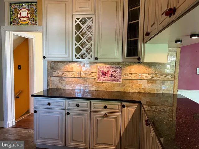 a kitchen with granite countertop a sink and cabinets